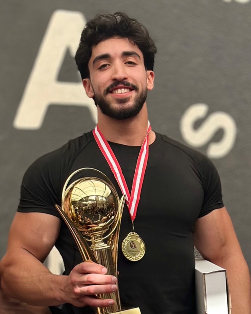 Youssef Yehya holding a first-place trophy at the Lebanese Streetlifting National Championship