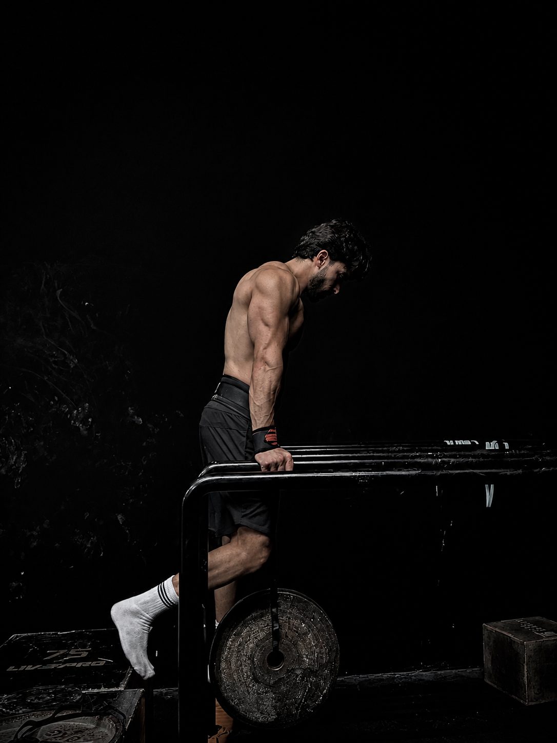 Youssef Yehya performing a weighted dip on parallel bars
